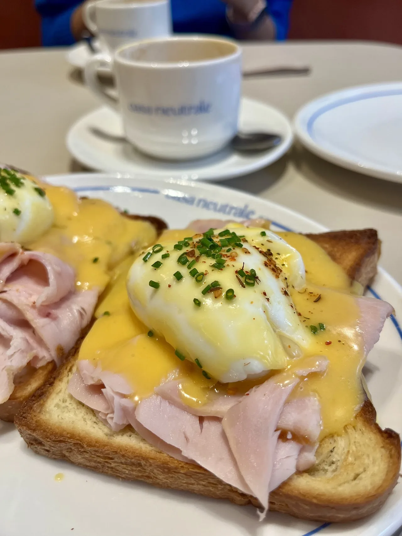 A toast topped with ham, poached egg, and hollandaise sauce