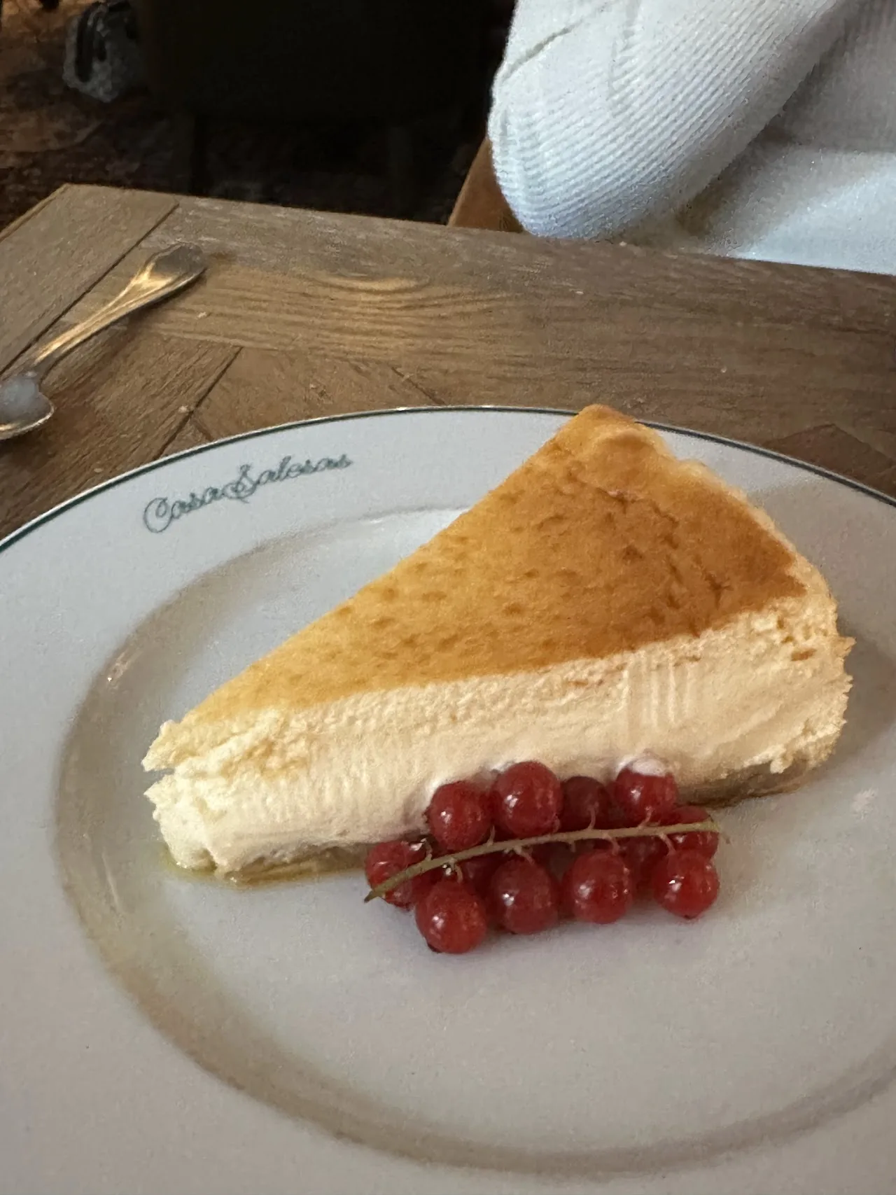 A slice of cheesecake with fresh red currants on top