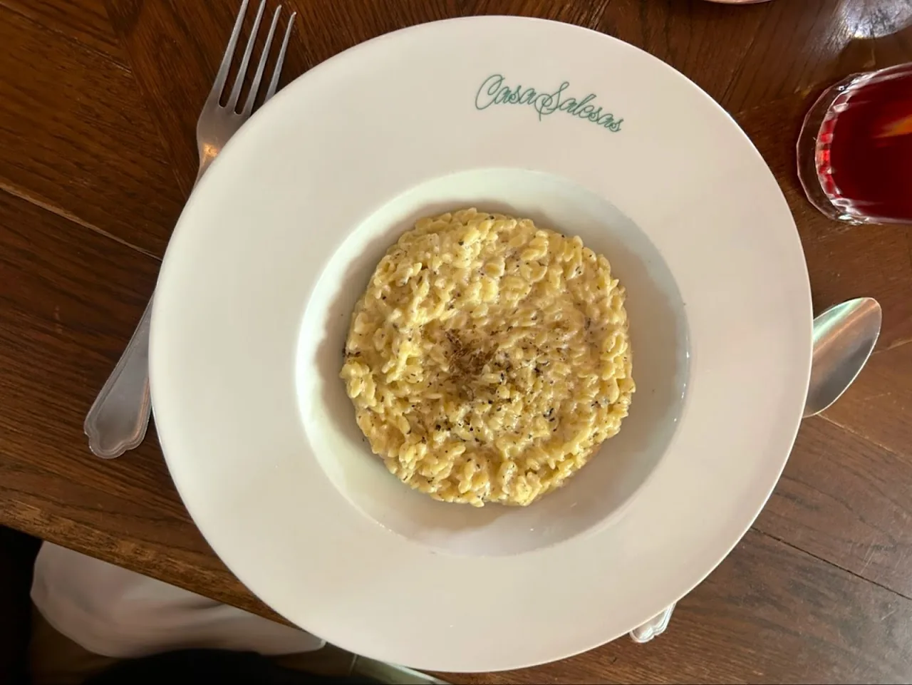 A round plate with a serving of scrambled eggs or creamy rice