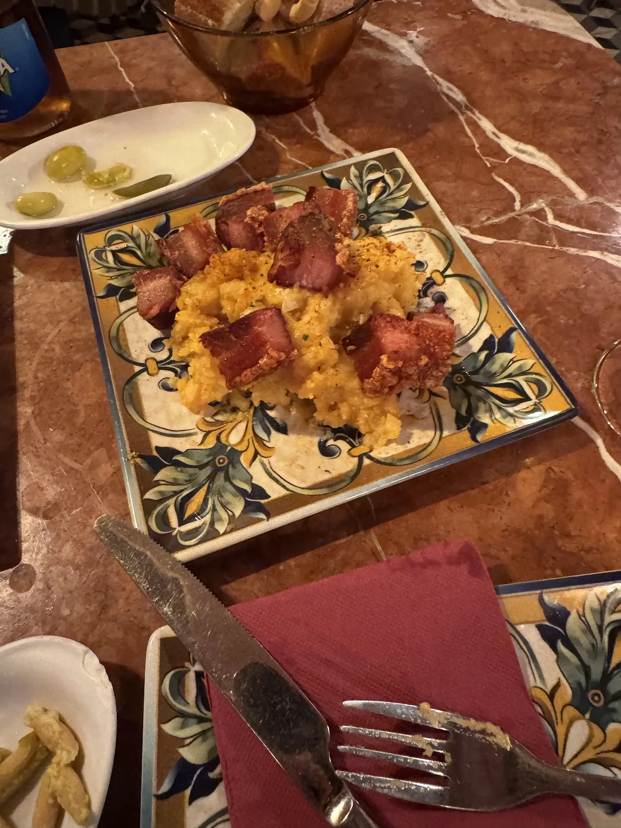 Fried breadcrumbs topped with diced cured ham on a decorative plate