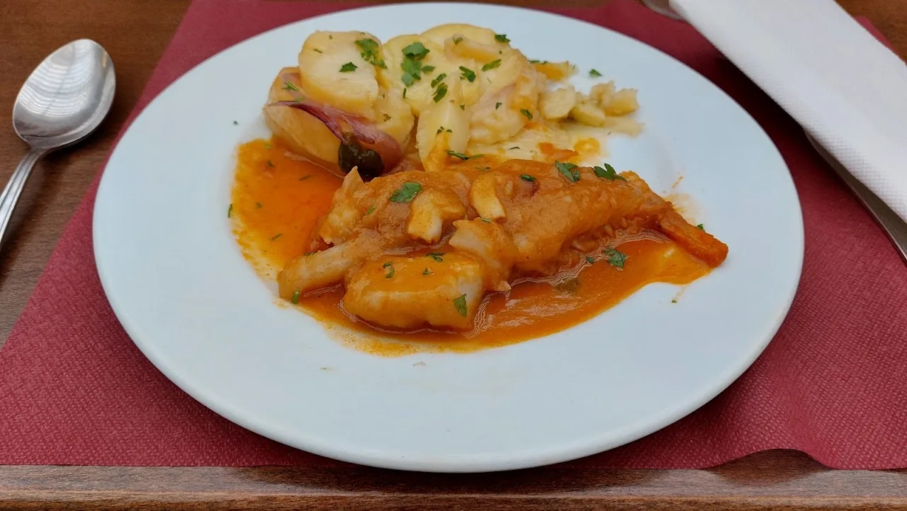 A plate of fish or seafood stew in a light sauce