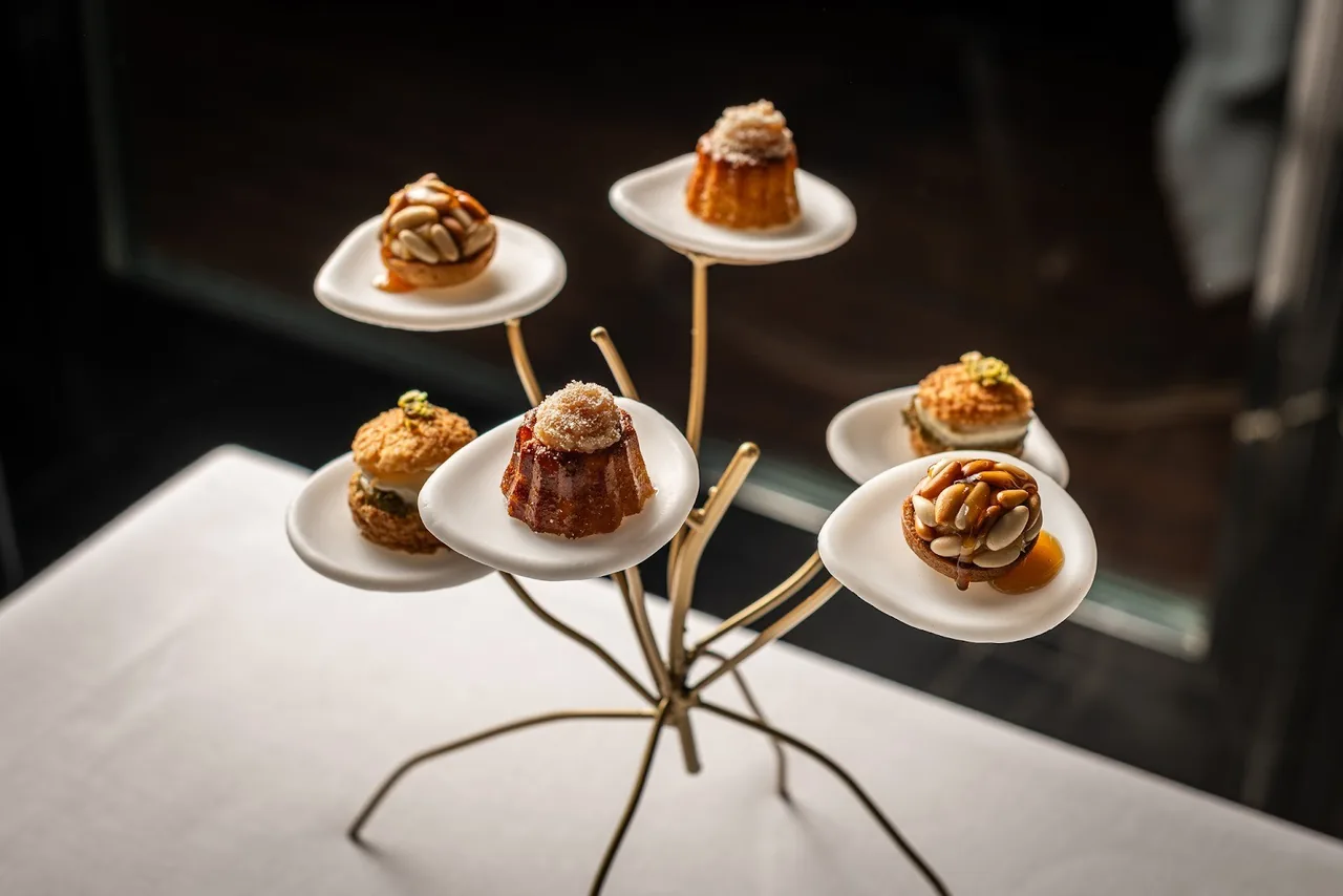 Small plates on a metal stand holding bite-sized canapés