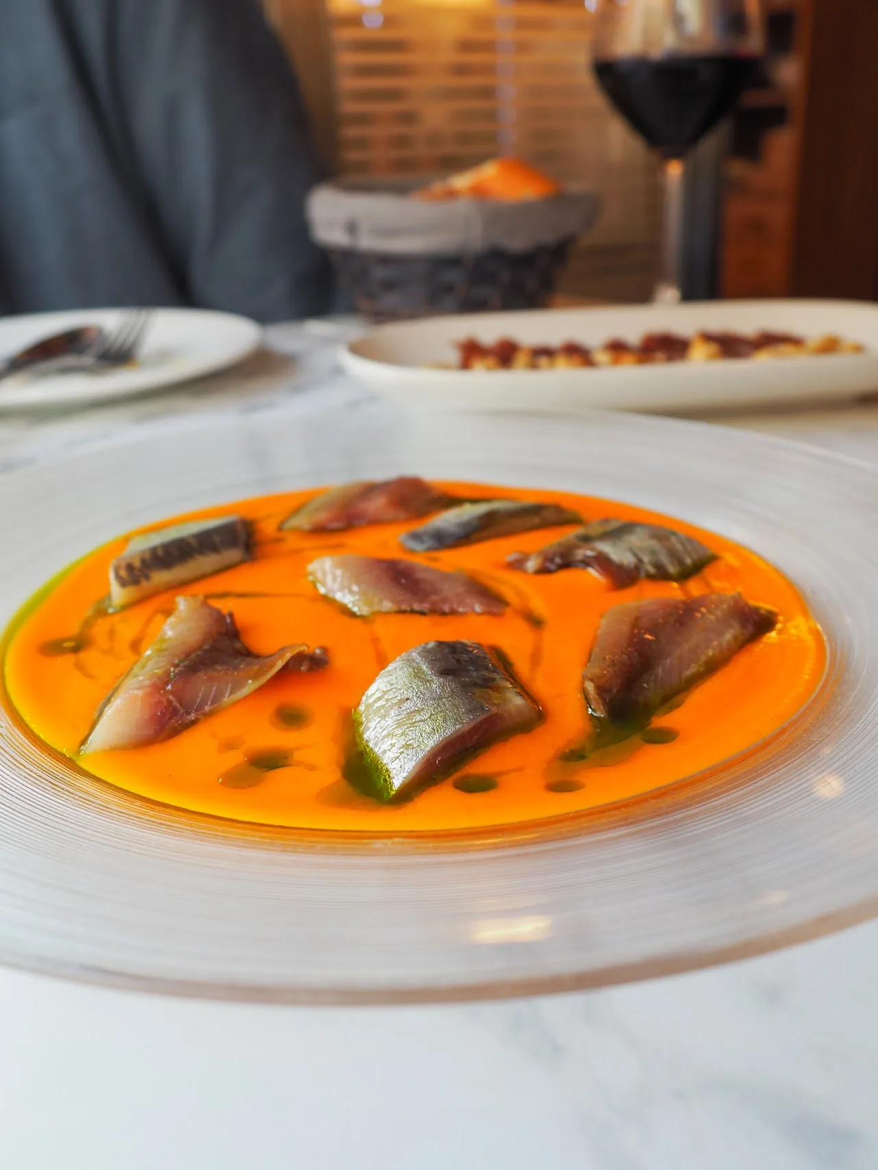 Marinated fish fillets served on an orange plate