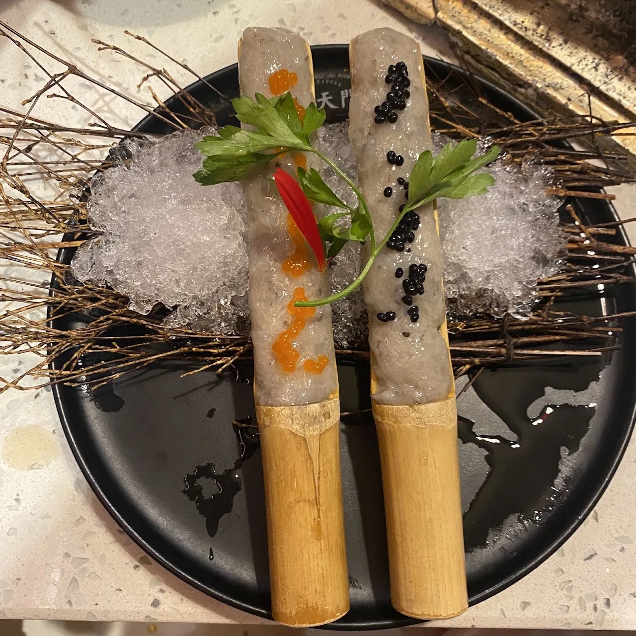Seafood skewers served on crushed ice with chili and herb garnish