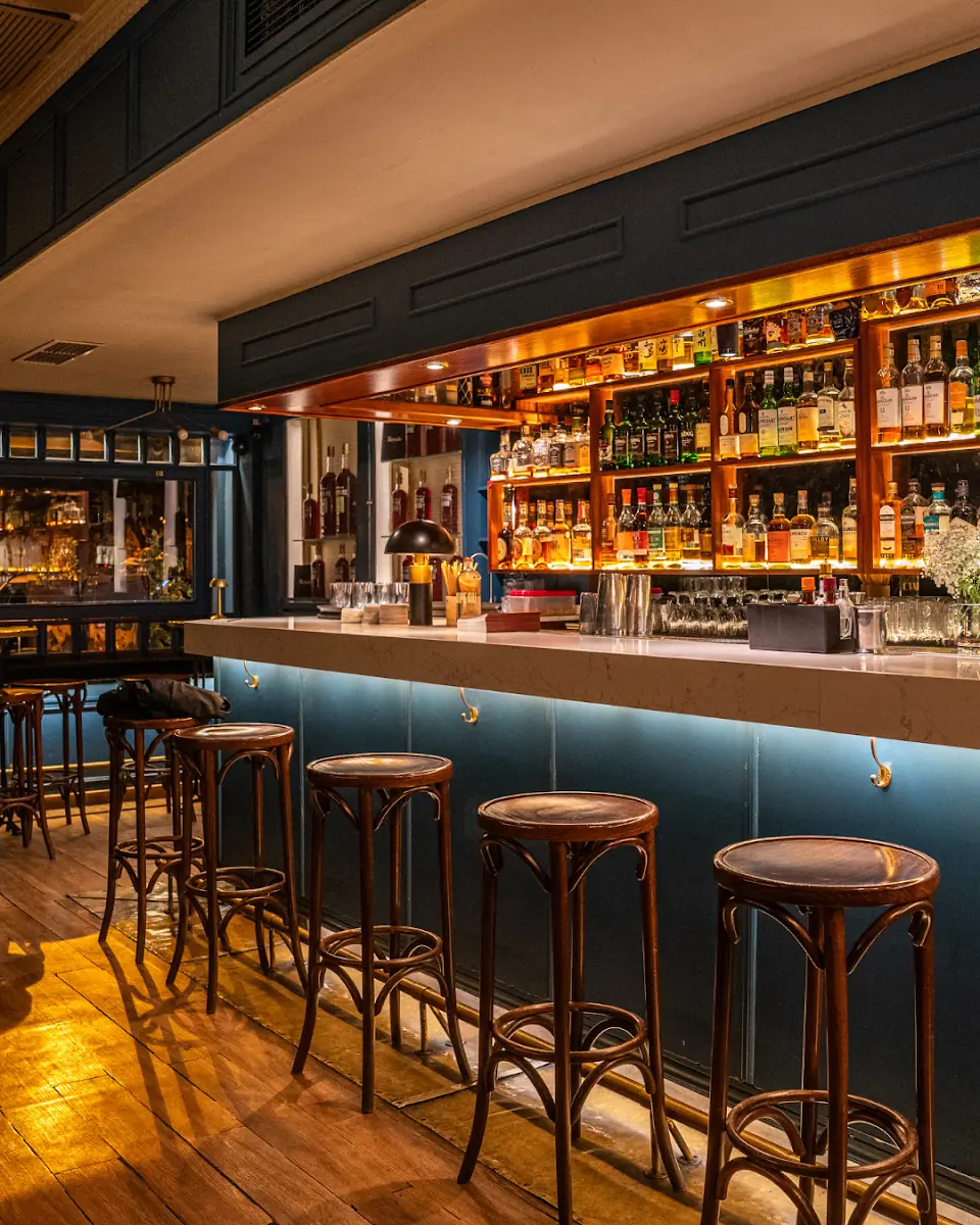 The bar and stools inside Chapeau 1987