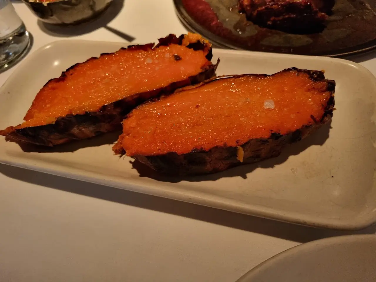 Two roasted sweet potato halves on a plate