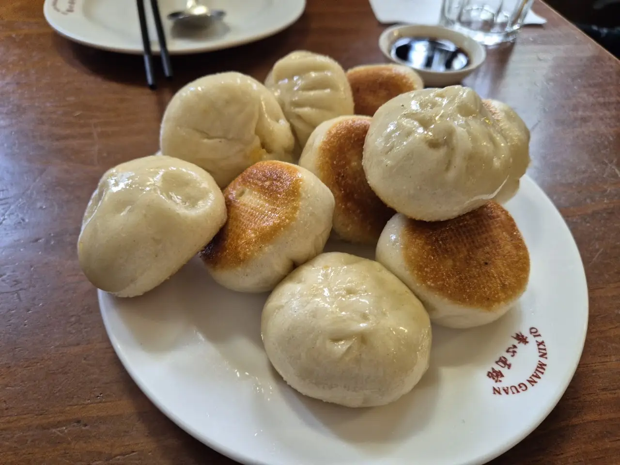 Plate of pan-fried pork buns (sheng jian bao), at Chen Ji.
