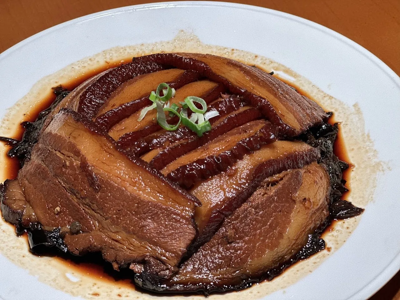 Braised pork belly slices in a glossy dark sauce