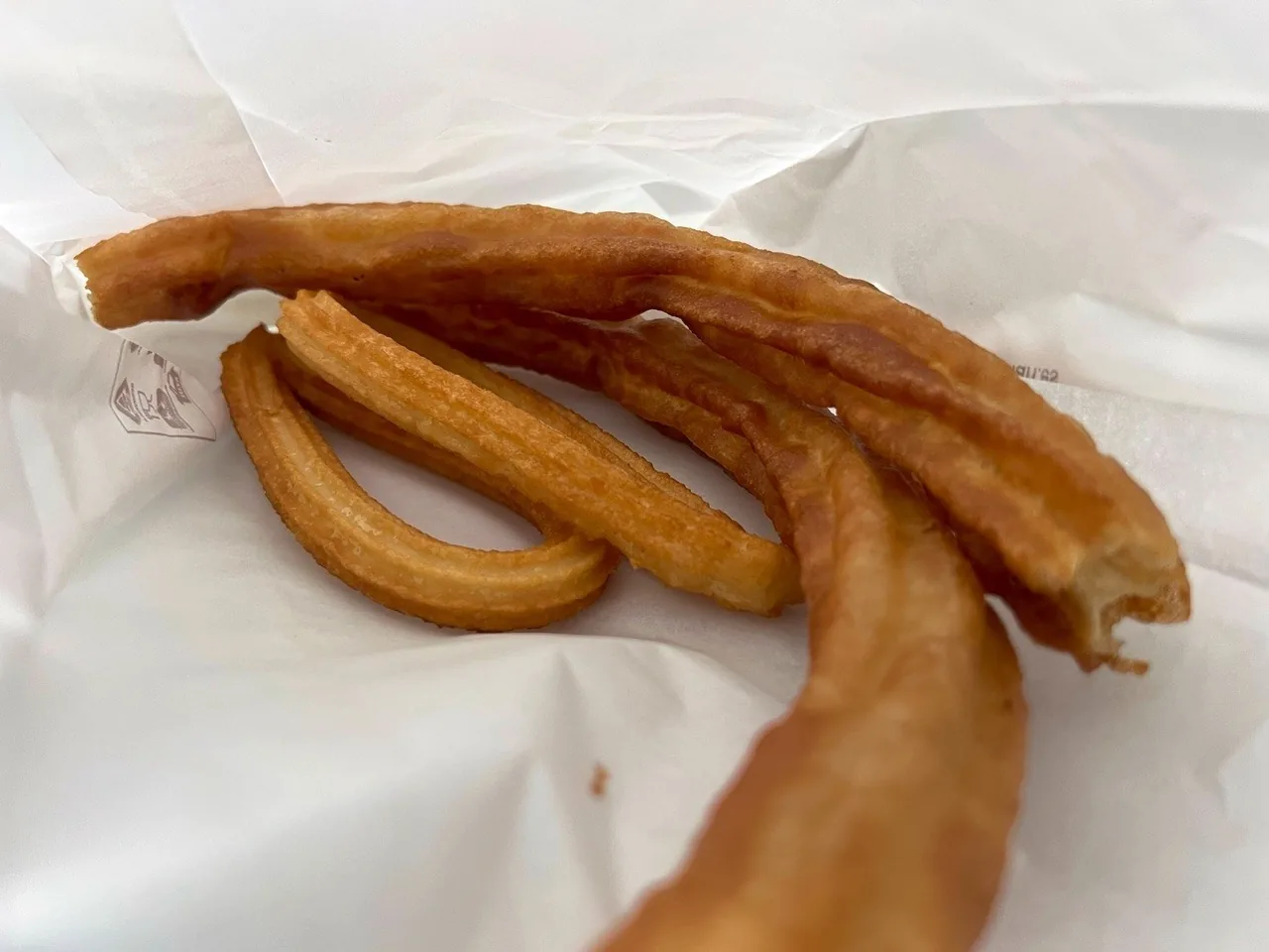Churros lying on white paper