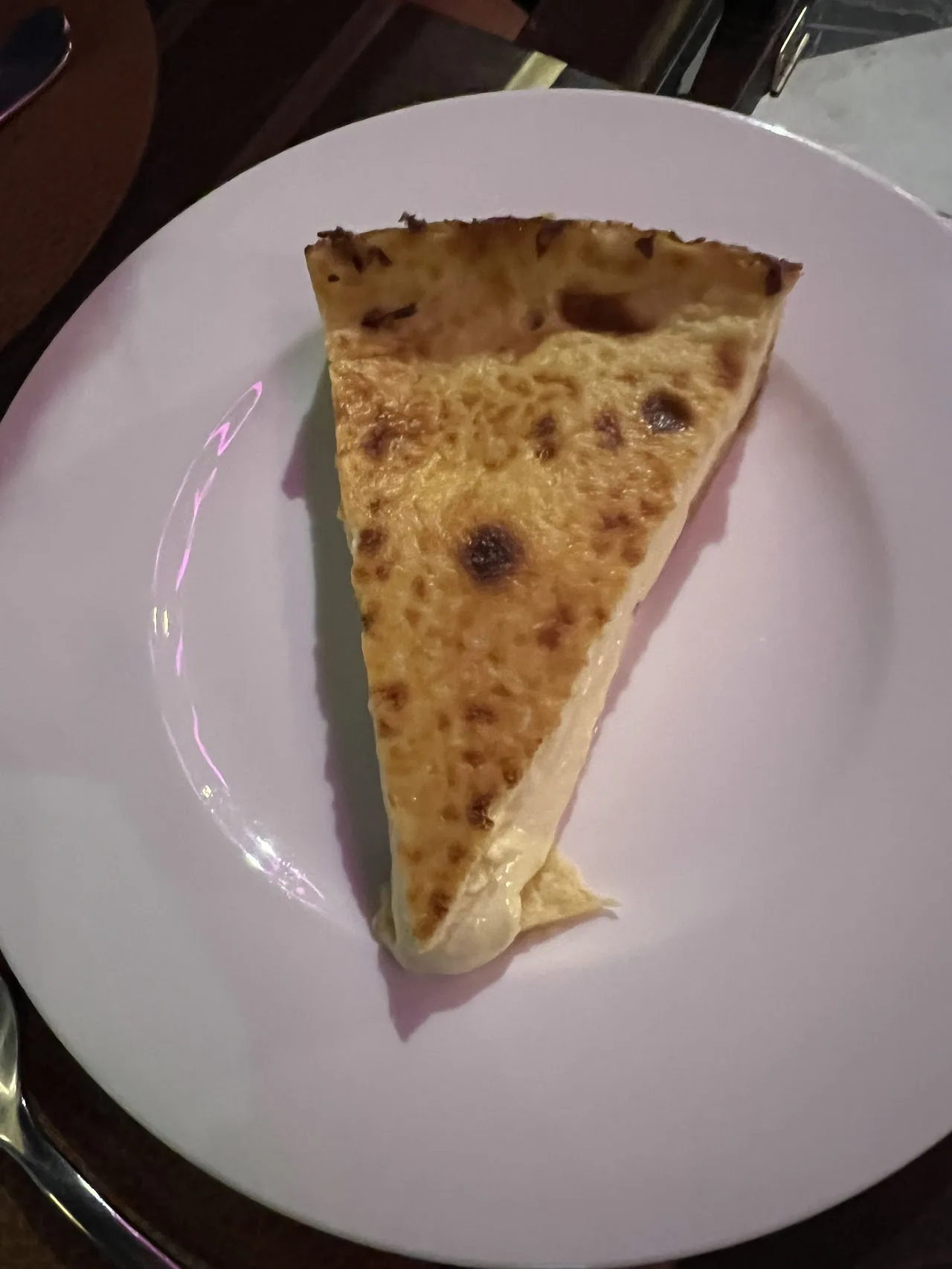 A wedge of Spanish tortilla on a white plate