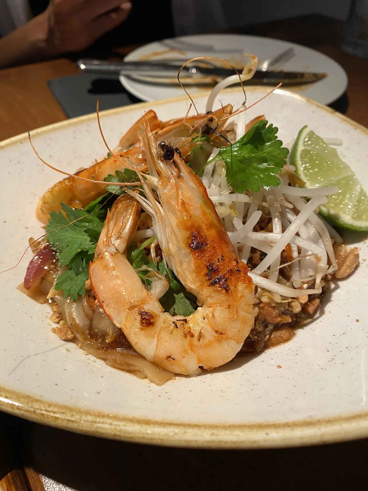 Grilled shrimp skewers with herbs and lime on a plate