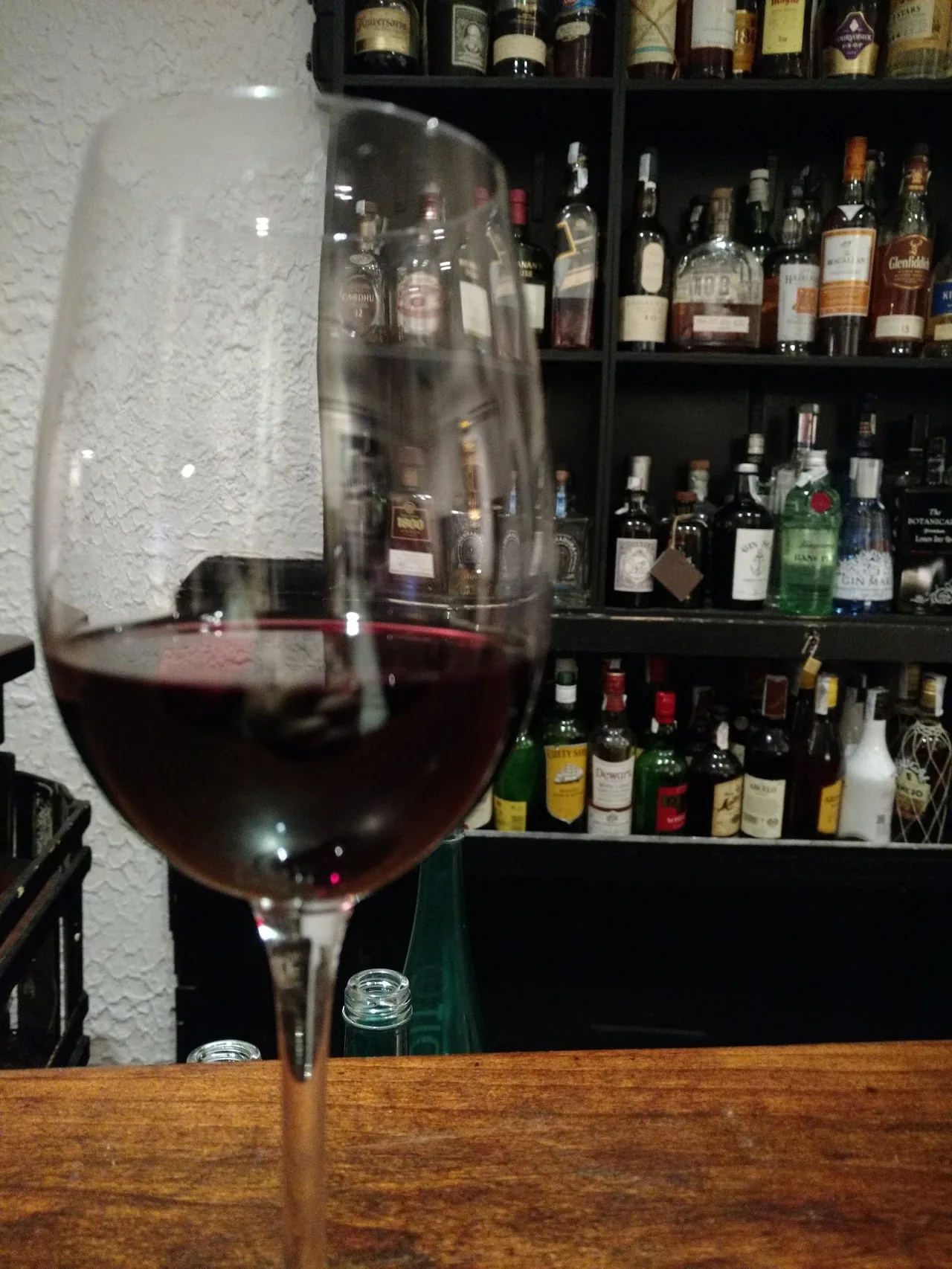 A glass of red wine at a bar