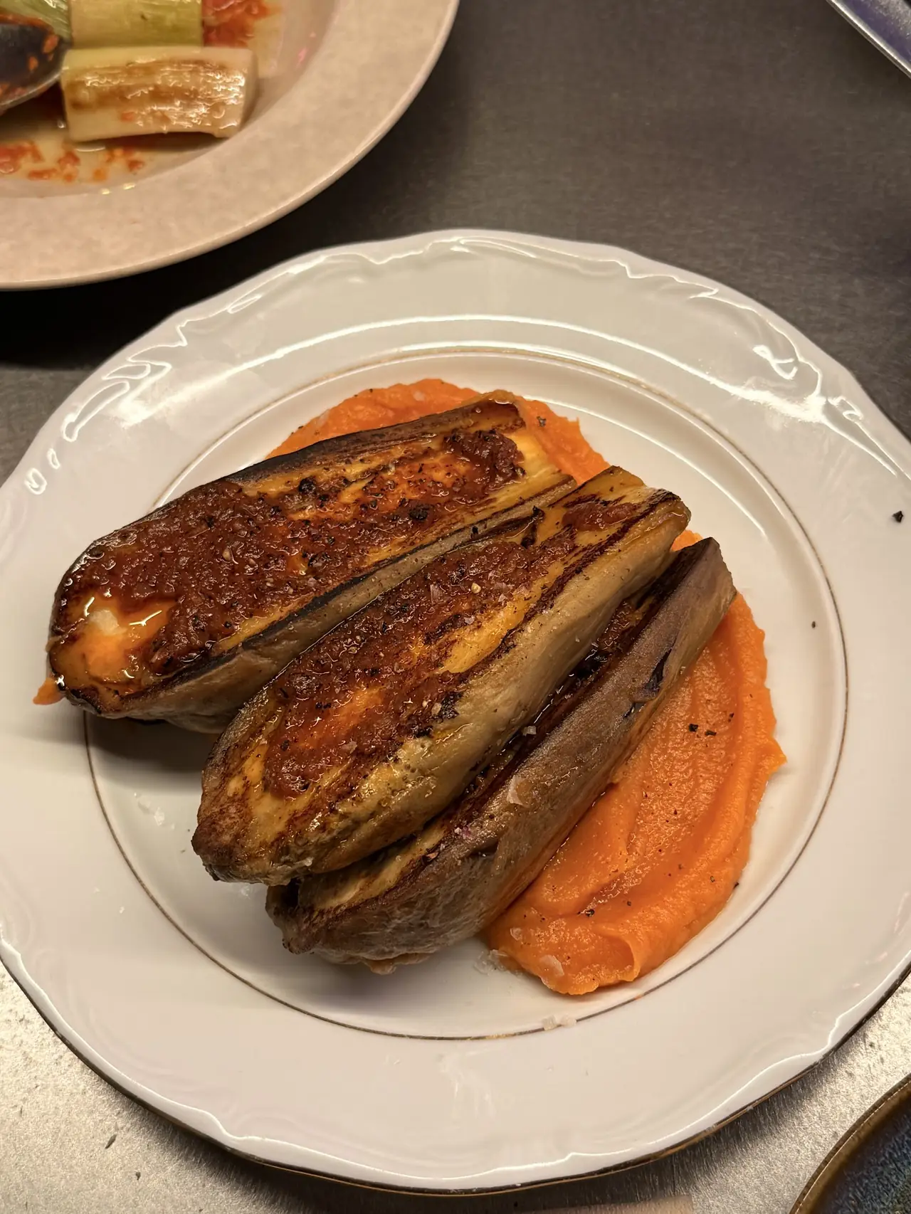 Roasted eggplant halves over sweet potato puree