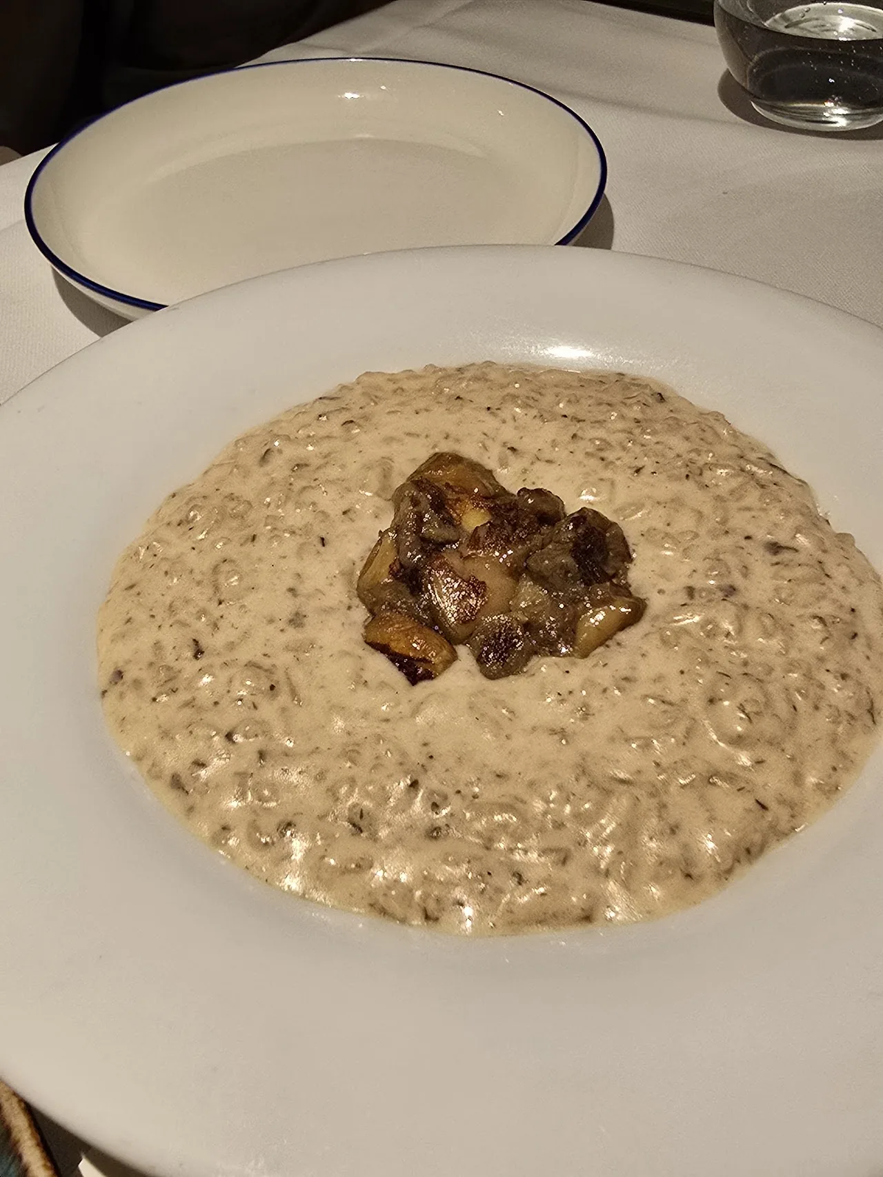 A creamy risotto topped with a mushroom