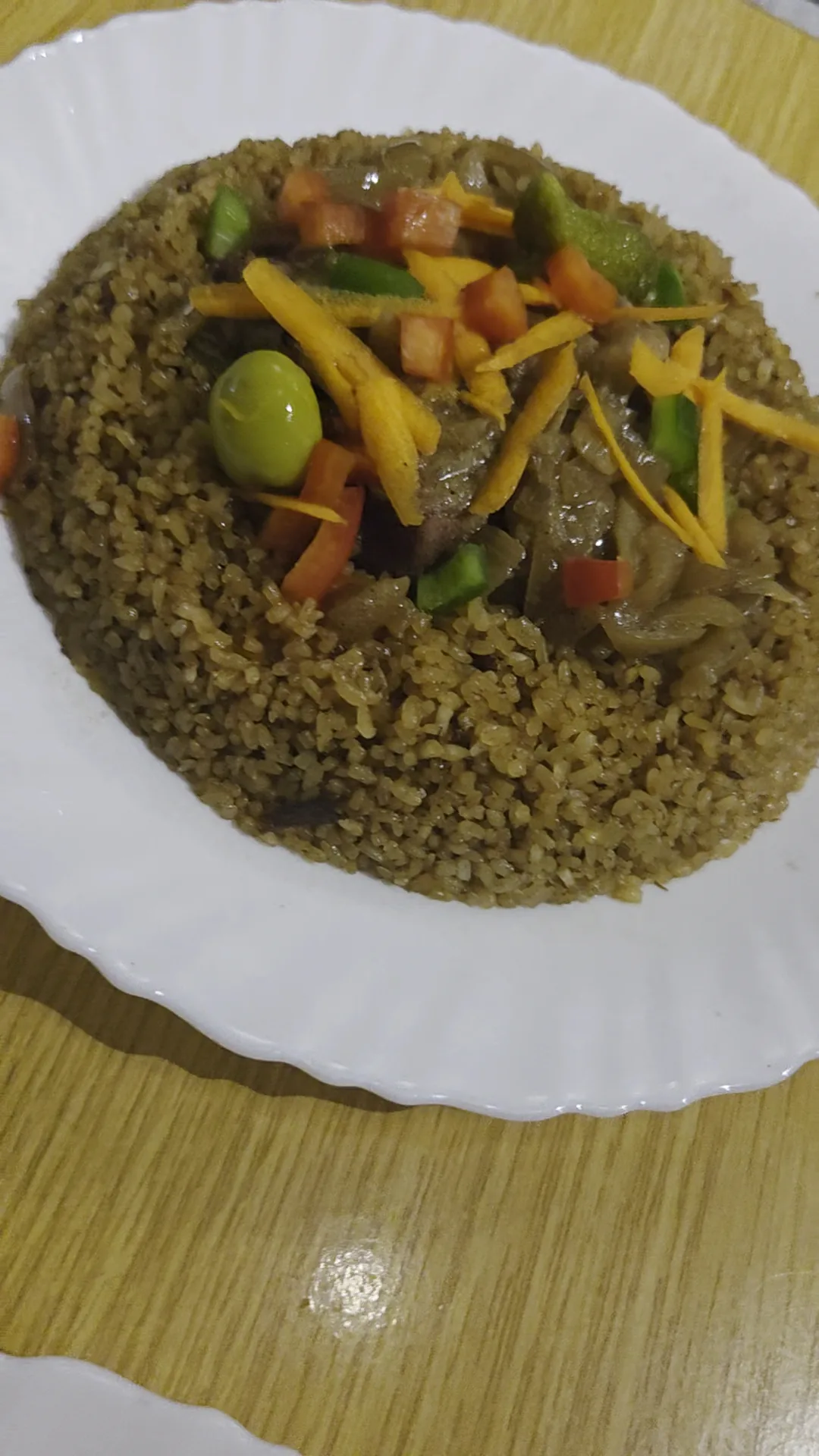 A plate of rice with mixed vegetables