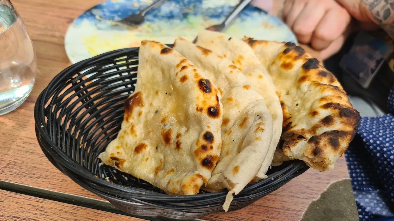 A basket of charred naan bread