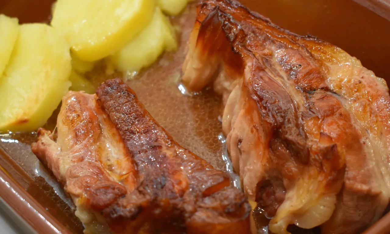 Roast meat with potatoes in an earthenware dish
