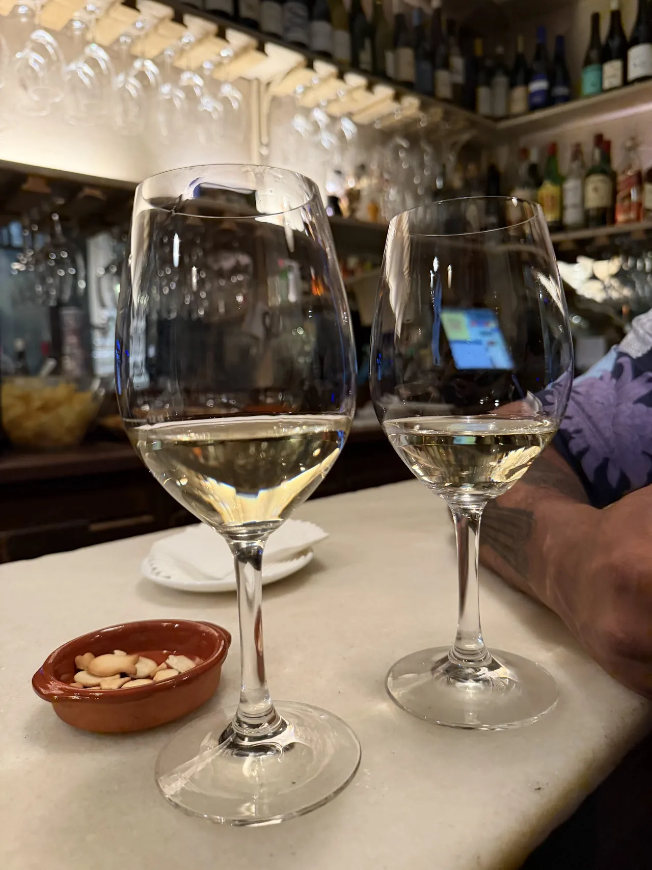 Two glasses of white wine on the bar
