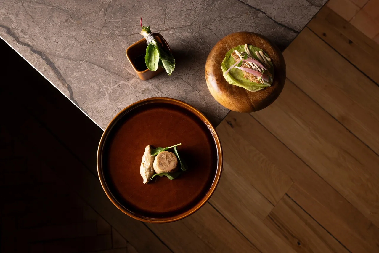 An overhead view of three small dishes on a stone counter