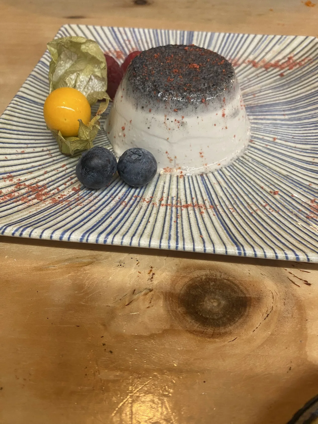 A dessert of panna cotta with physalis and blueberries