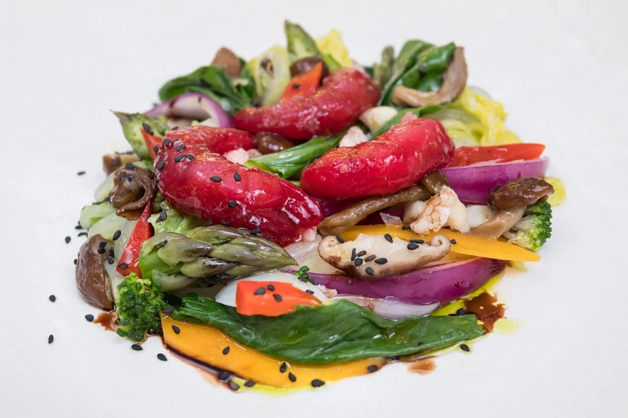 A colorful salad with pickled beets, vegetables, and greens