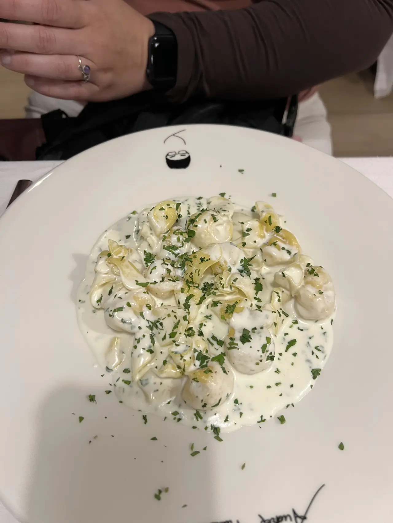 Filled pasta in a creamy herb sauce topped with chopped parsley