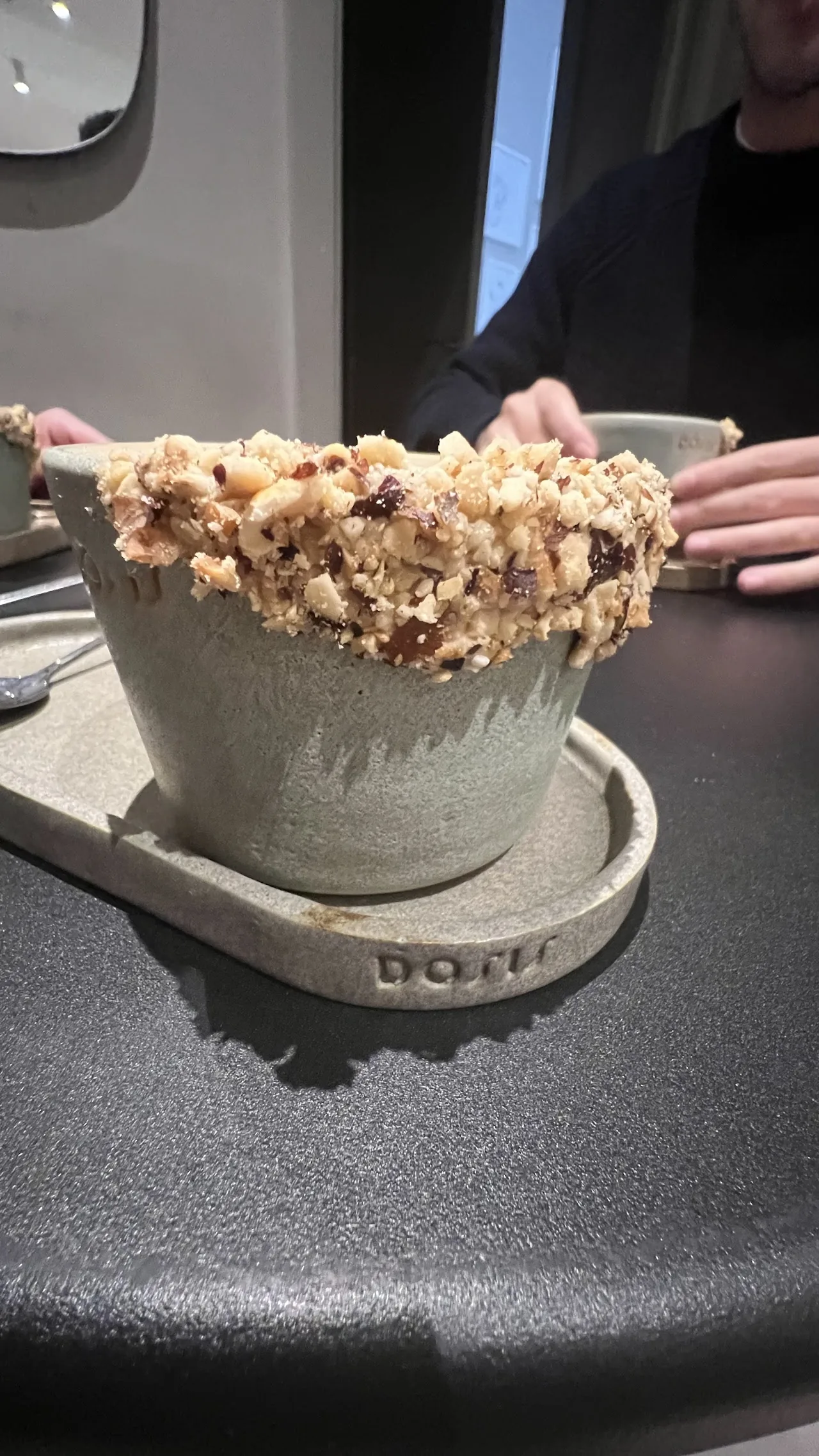 A bowl of granola topped with nuts