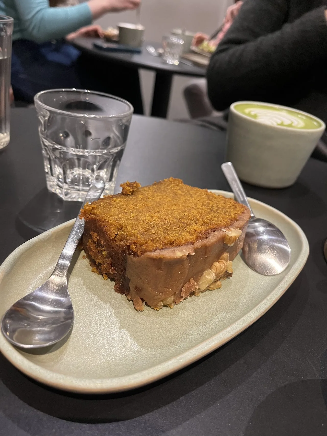 A slice of spiced cake on a plate with a spoon