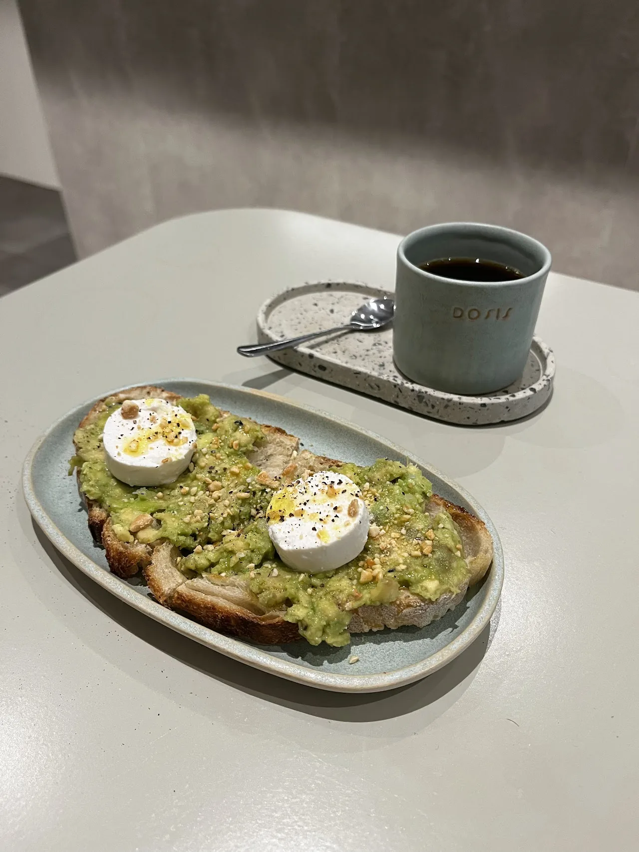 Avocado toast topped with a poached egg, cut in half