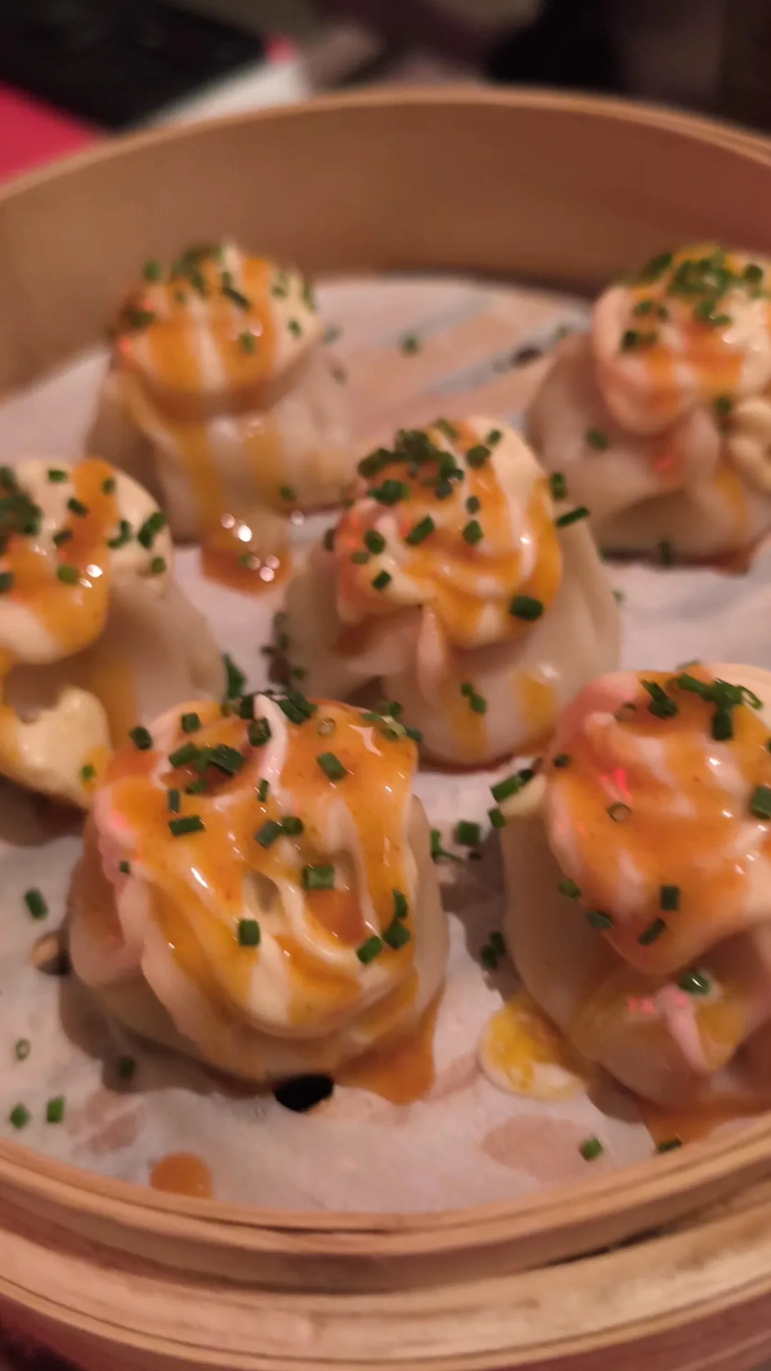 Dumplings drizzled with a pink sauce