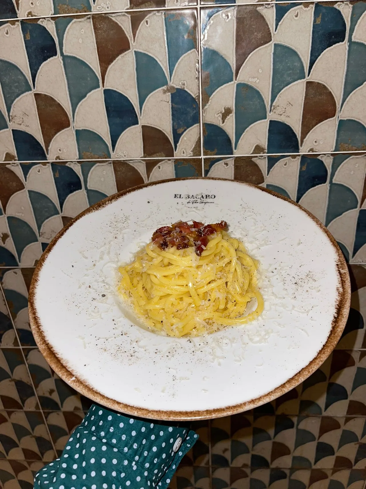 A plate of spaghetti in a light butter sauce with cheese