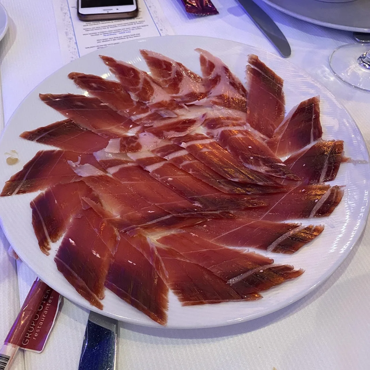 A plate of thinly sliced cured ham fanned out