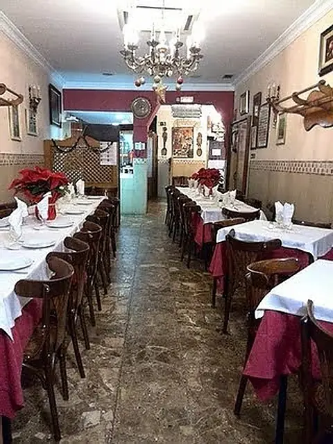 Traditional dining room with red tablecloths and wood-paneled walls