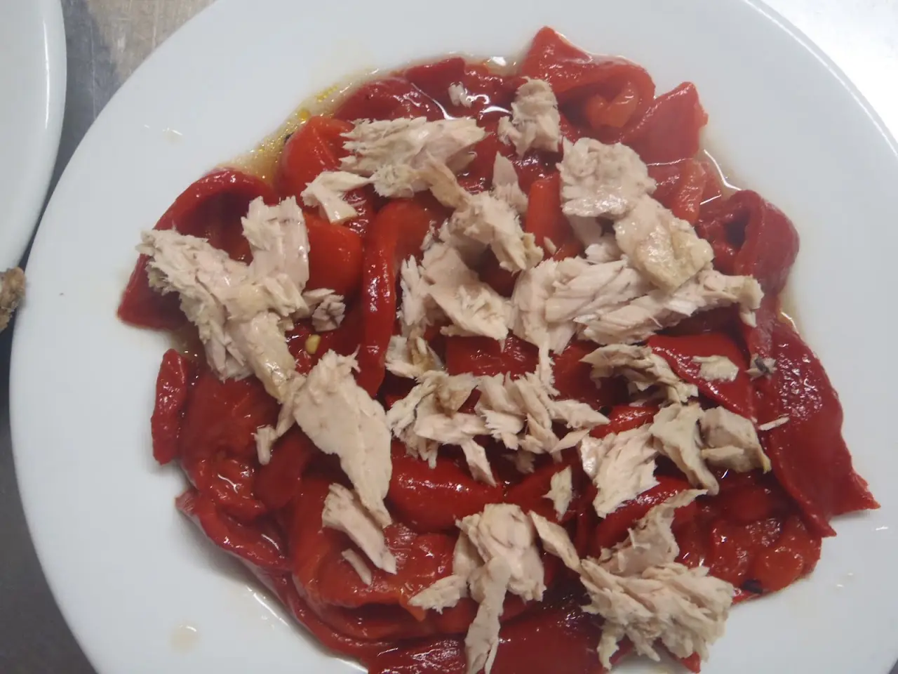 Roasted red pepper strips topped with shredded tuna