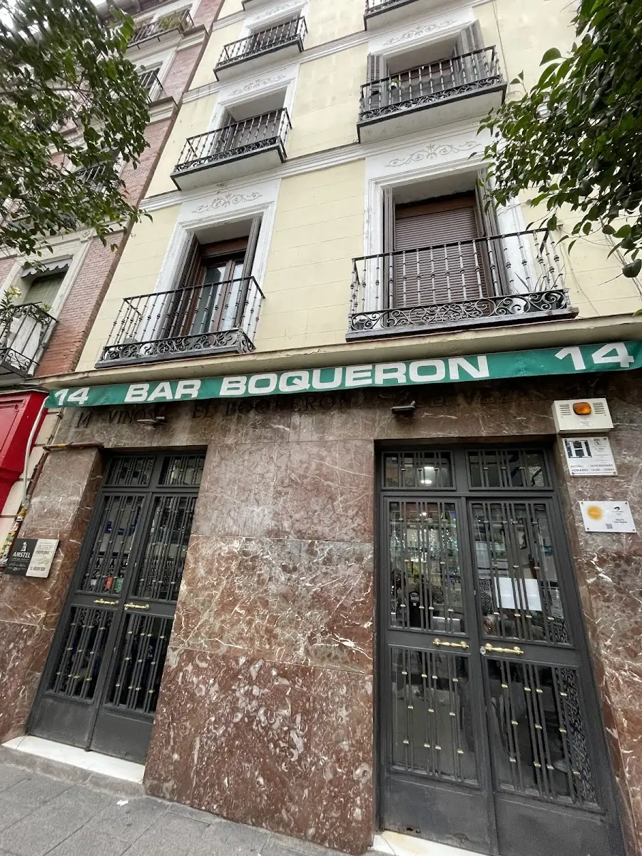 Exterior of Bar Boqueron with green sign reading BAR BOQUERON 14 above marble-framed doors