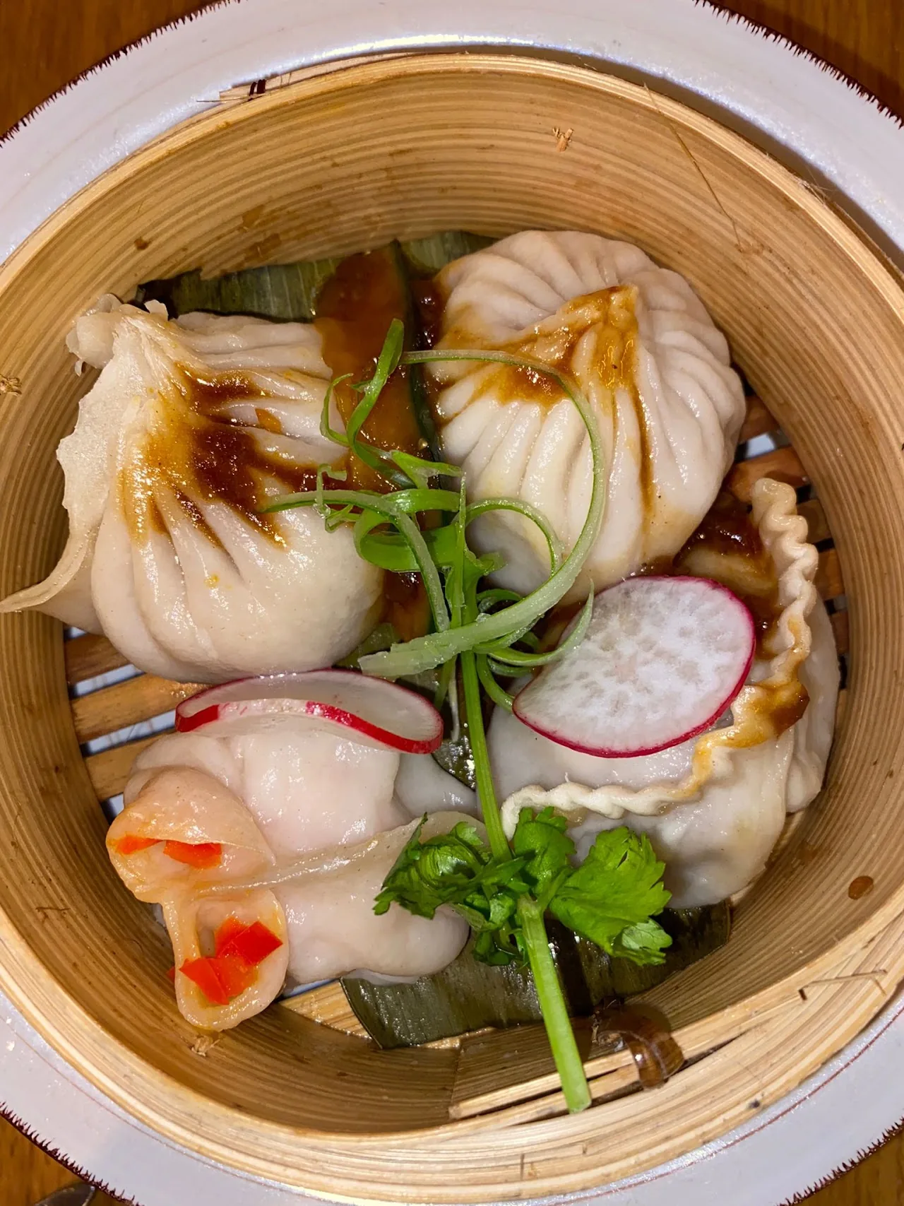 Steamed dumplings in a bamboo steamer basket