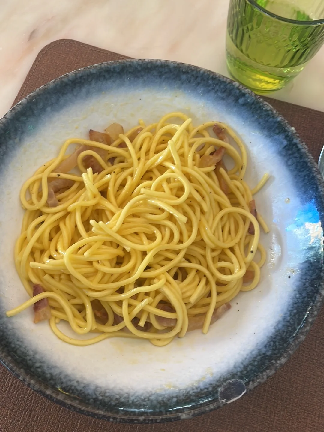 A plate of spaghetti in a light sauce