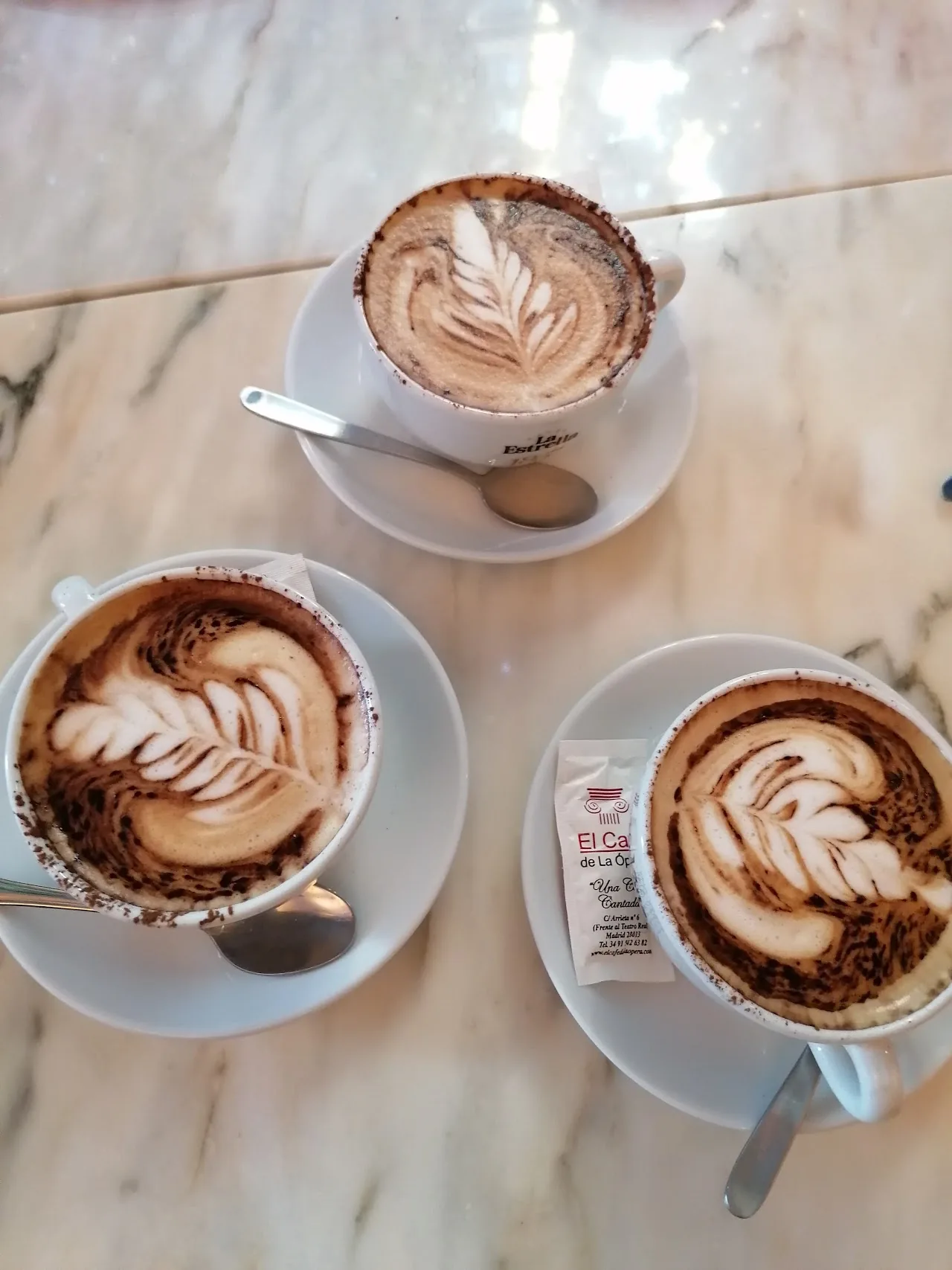 Three cups of coffee with latte art
