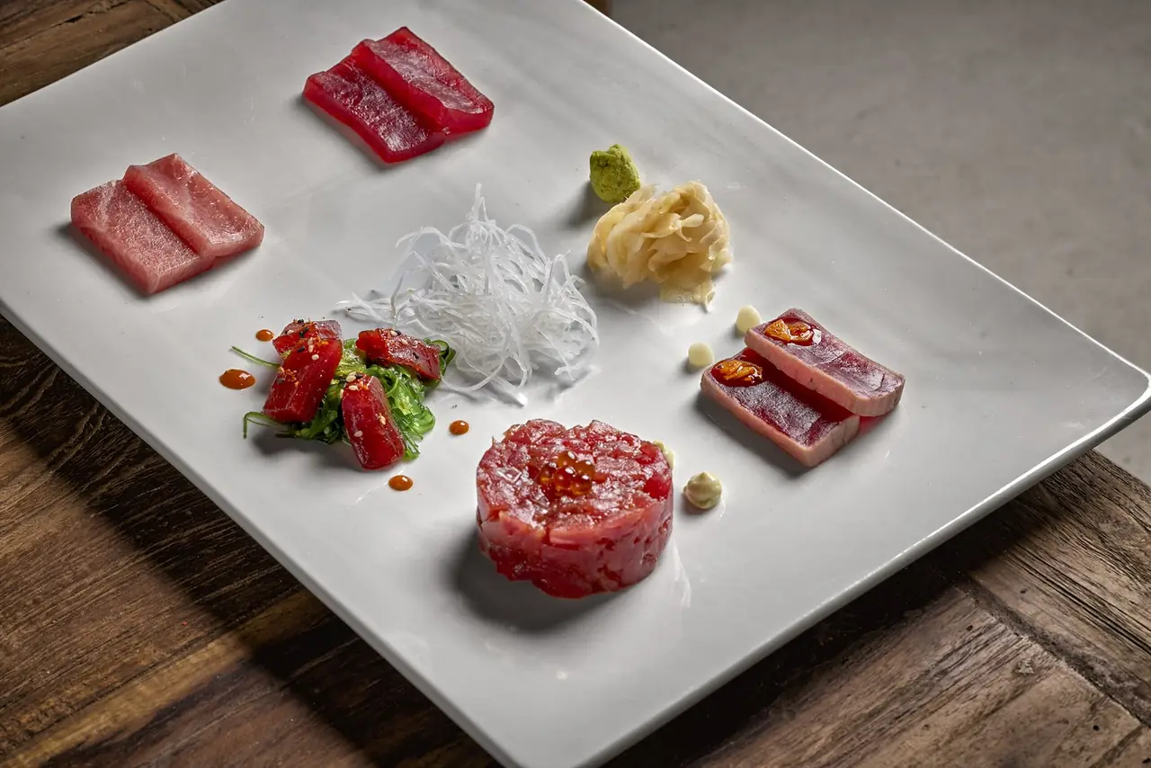 Bluefin tuna tasting plate with sashimi, tartare, seared loin, wakame salad, ginger and wasabi