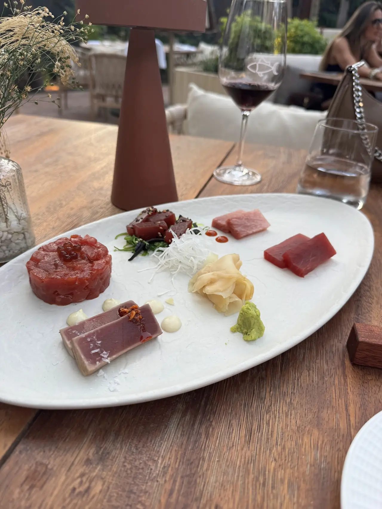 Bluefin tuna tasting plate with tartare, sashimi and seared cuts on an outdoor restaurant table