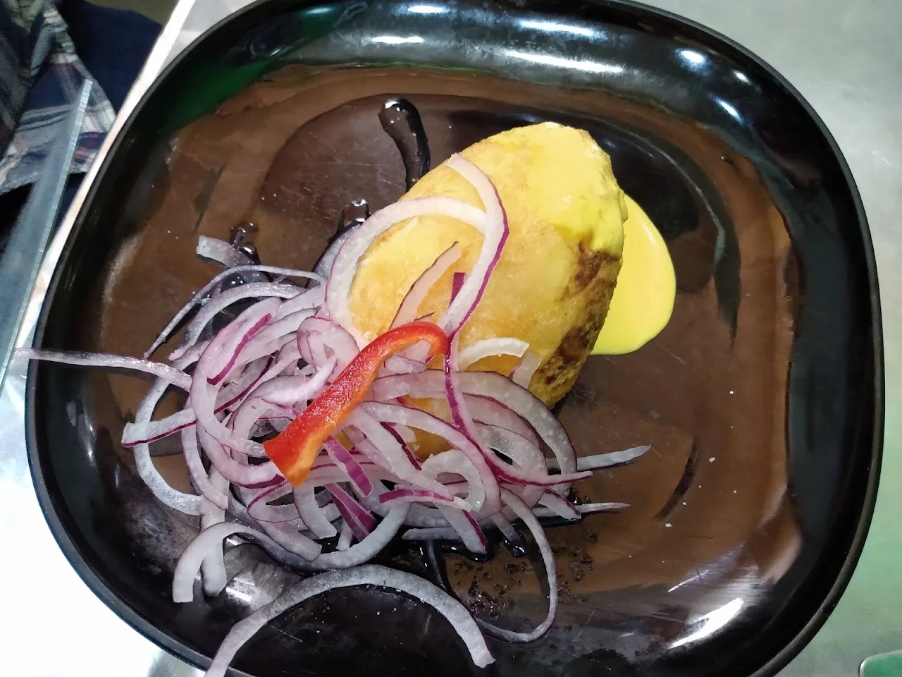 Peruvian ceviche with red onion and yellow corn