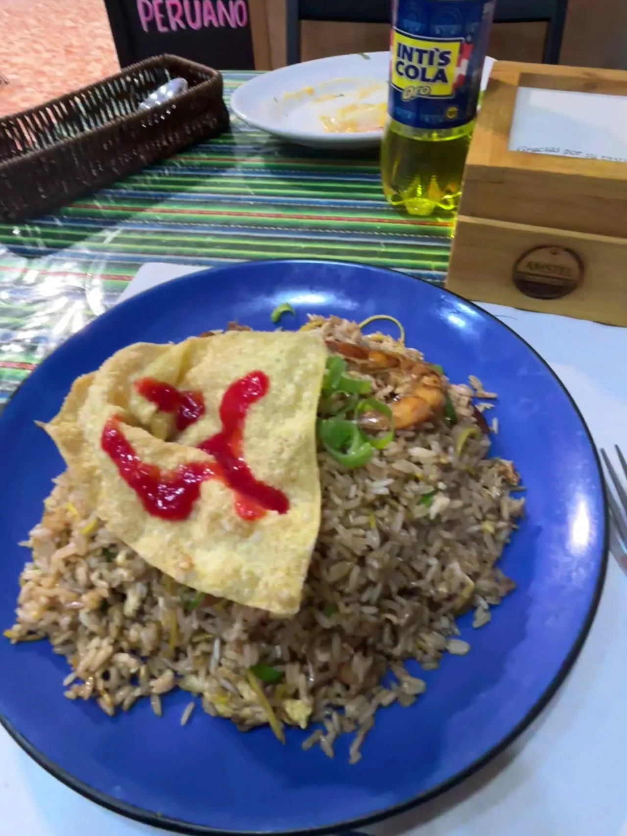 A plate of rice with meat and a fried plantain