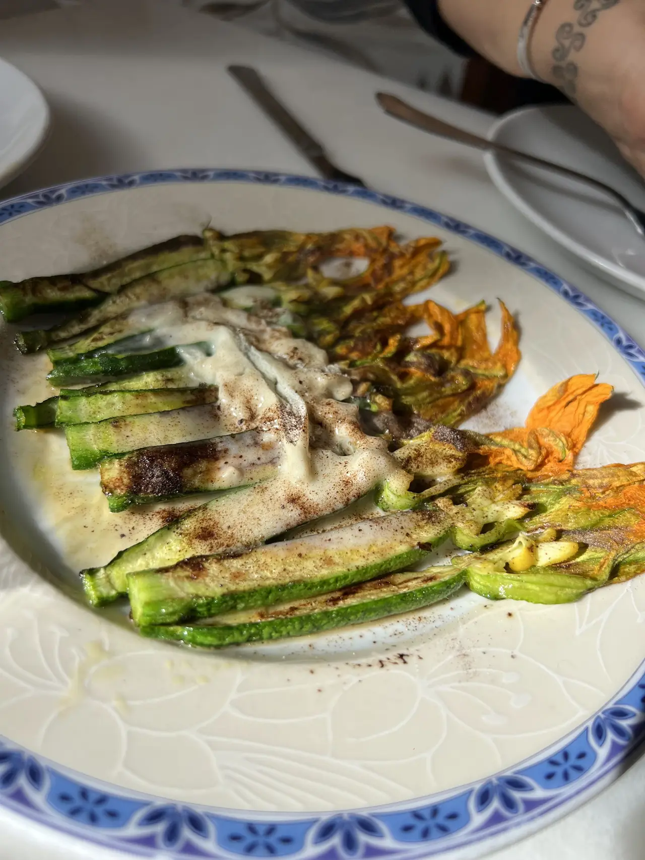 Grilled zucchini spears and squash blossoms with a cream sauce