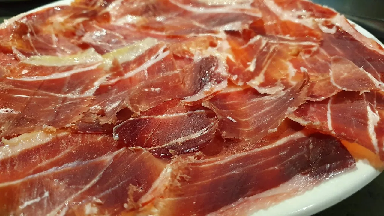 A platter of thinly sliced cured ham