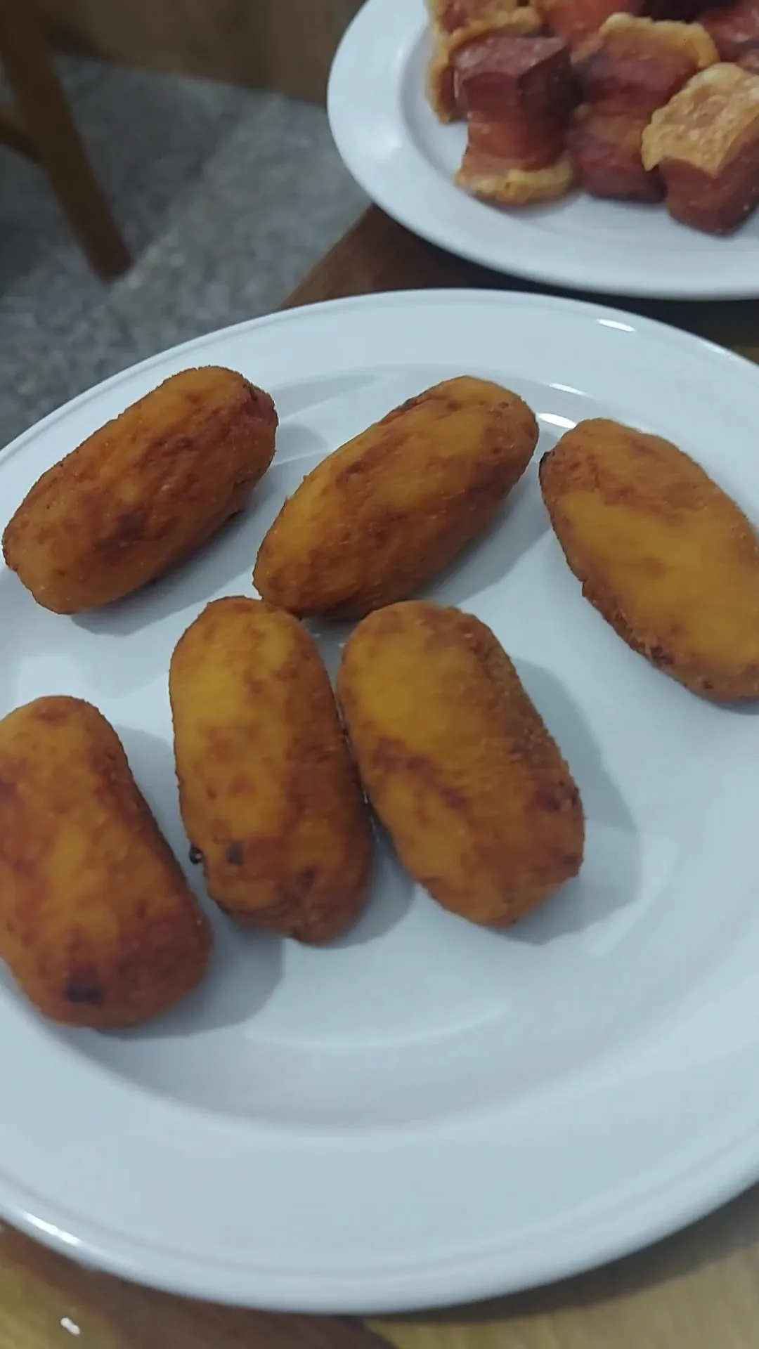 A plate of golden fried croquettes