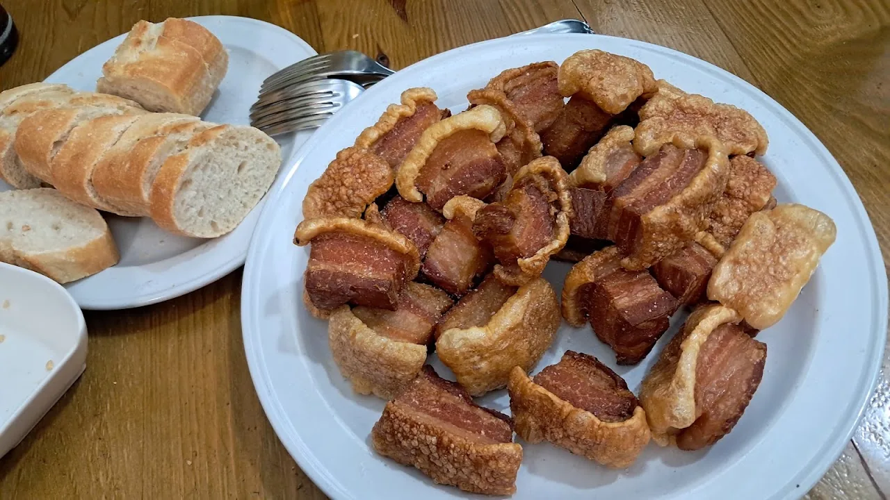 A plate of fried chorizo bites with sliced bread