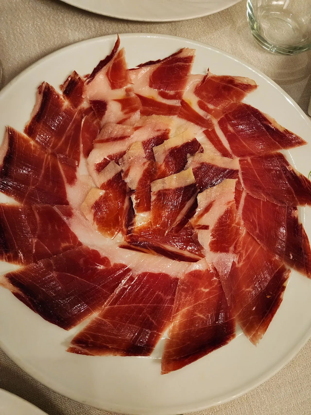 Thinly sliced cured ham fanned out on a plate