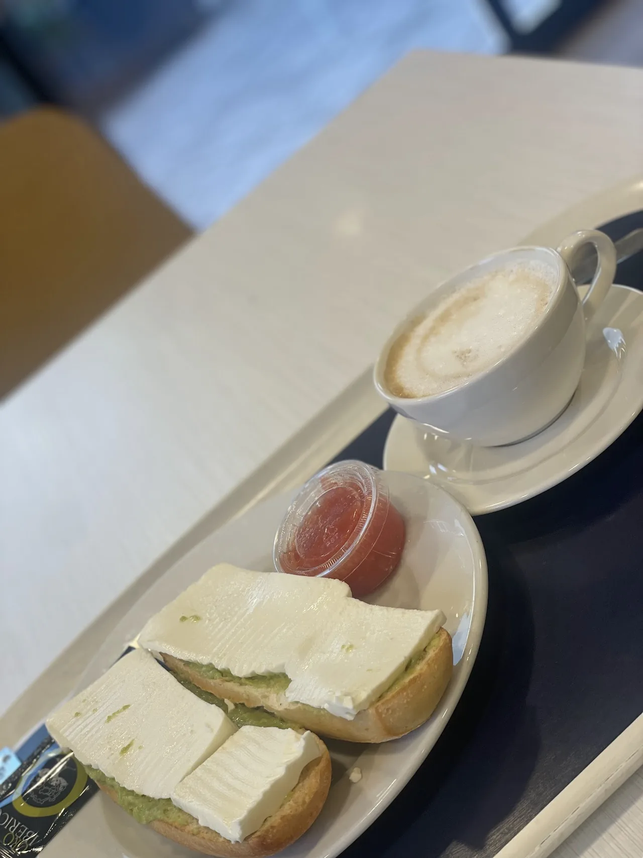 A tray with coffee, toast, and slices of ham and cheese