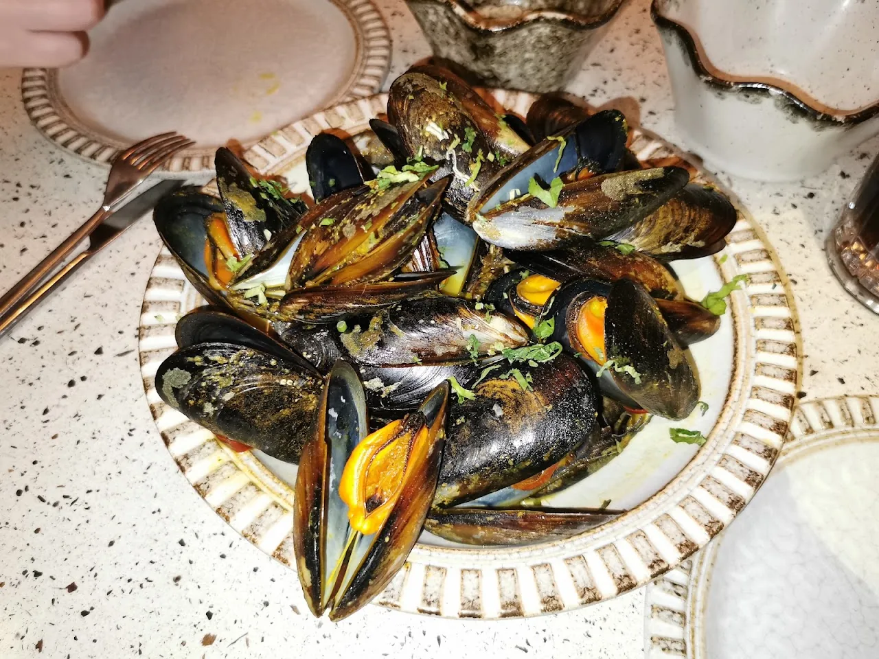 A plate of steamed mussels in their shells