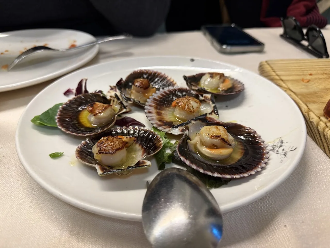 Grilled scallops served in their shells with herbs